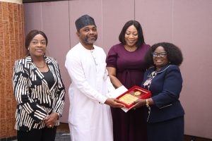 R-L: Representative of the Permanent Secretary State House, Mrs Adenike Akintola, presenting an award to Dr. Agbor Ebuta, flanked by Mrs Abimbola Olusola, Head of the Procurement Department and Dr Vicky Ogala-Akogwu, Chairman, Medical Advisory Committee, State House Medical Centre at the 2025 State House Ministerial Rewards and Recognition Ceremony at the State House.